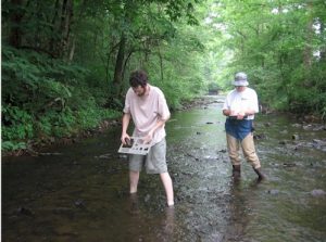 Graduate student Chris Morris (left) and Ann McGhee measuring rocks on the bed of Hesse Creek.